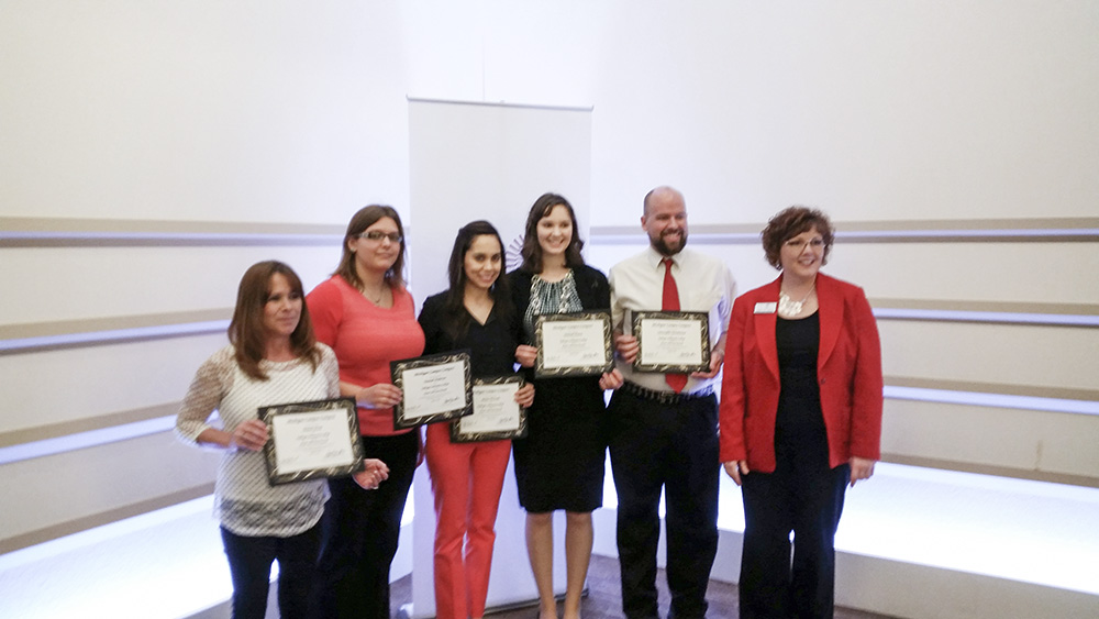 A group photo of, from left to right, KCC student award winners Donna Street, Hannah Anderson, Mayra Hurtado, Hannah Frentz and Christopher Stoneburner, with Michigan Campus Compact Executive Director Robin Lynn Grinnell. The photo was taken at a ceremony during which the organization honored the students for their service work in the community.