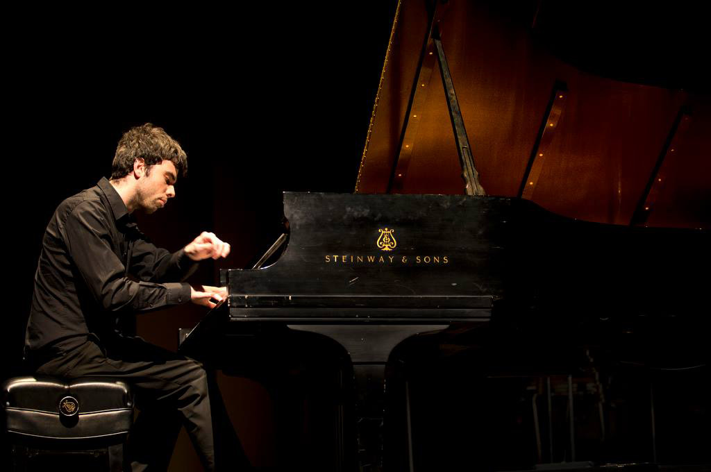 Pianist Miguel Sousa plays a piano in a provide photo used to promote Sousa's upcoming recital at KCC.
