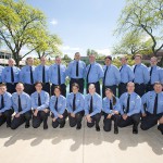 A group photo of KCC's 2014-15 Police Academy cadets, taken outside between the reflecting pools on the North Avenue campus in Battle Creek.