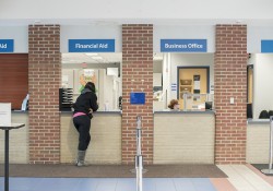 A student waits at the Financial Aid window on campus.