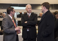 Mark O'Connell, center, converses with Bernhard Kerschbaum, Chief Executive Officer of Rosler Metal Finishing USA, left, and Drew Schweitzer, Vice President of Schweitzer Construction, right, during an event in November 2015. Photo by Sarah Huling.