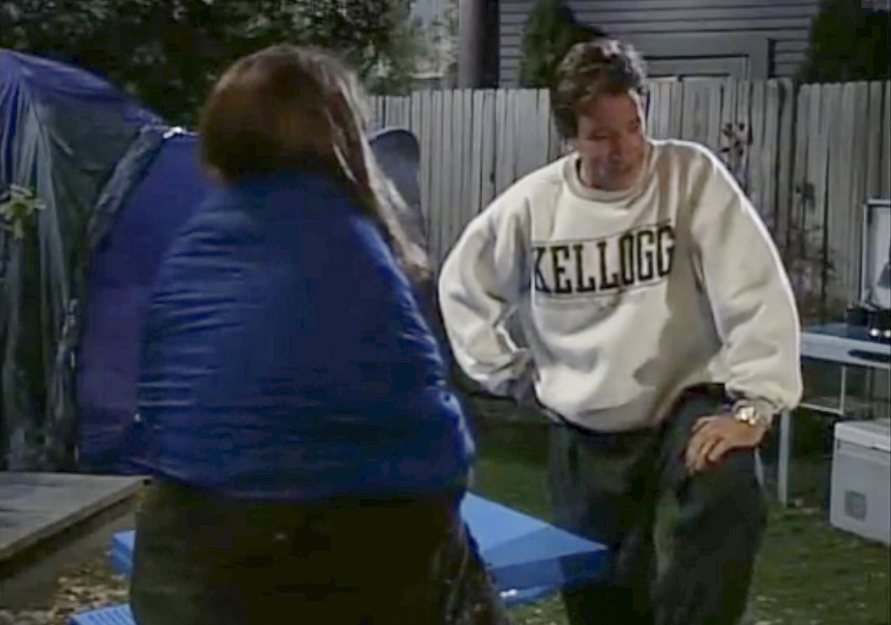 A screenshot of actor Tim Allen wearing a KCC sweatshirt in an episode of the 1990s television series "Home Improvement"