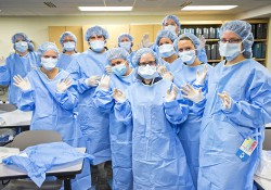 MRI Program students pose for a group photo in scrubs.