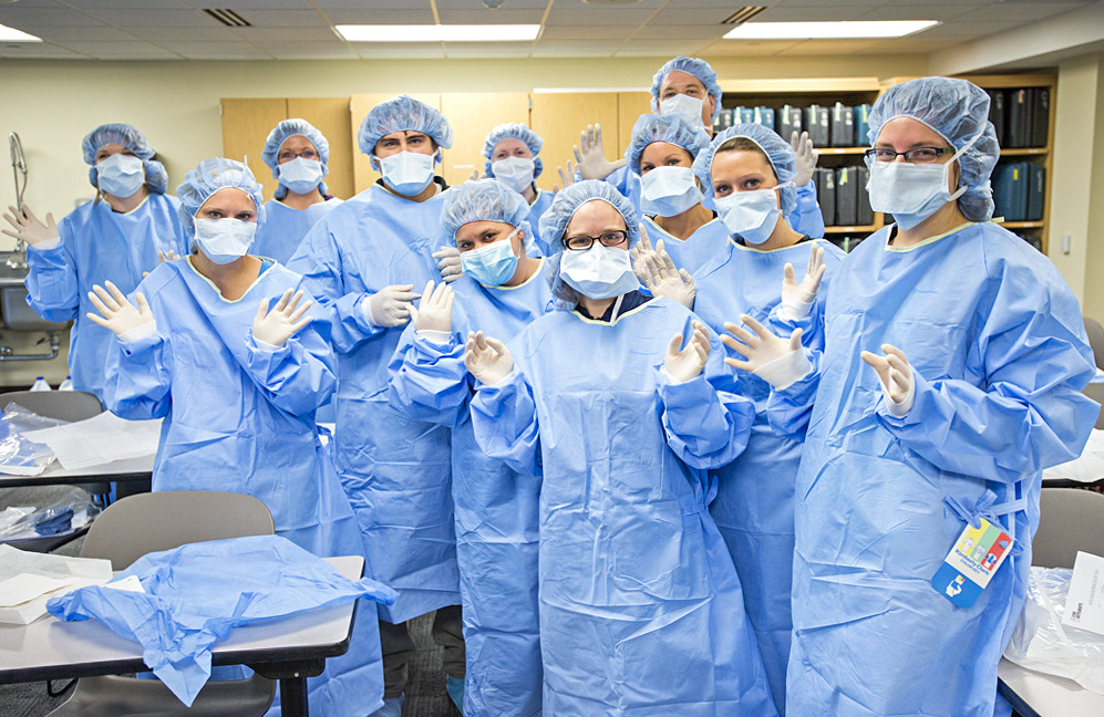 MRI Program students pose for a group photo in scrubs.