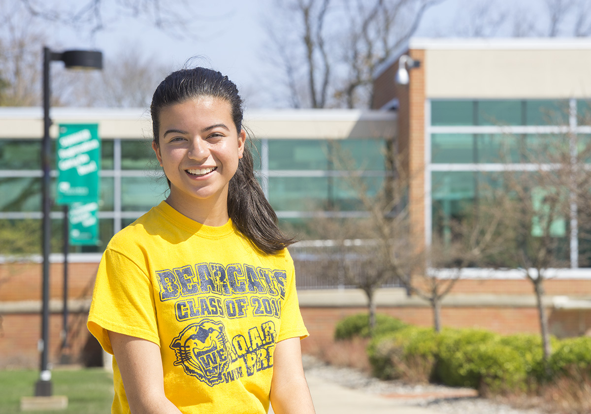 Battle Creek Central High School senior and KCC dual-enrollment student Yarielis Rosario poses near the entrance to KCC's North Avenue campus in Battle Creek.