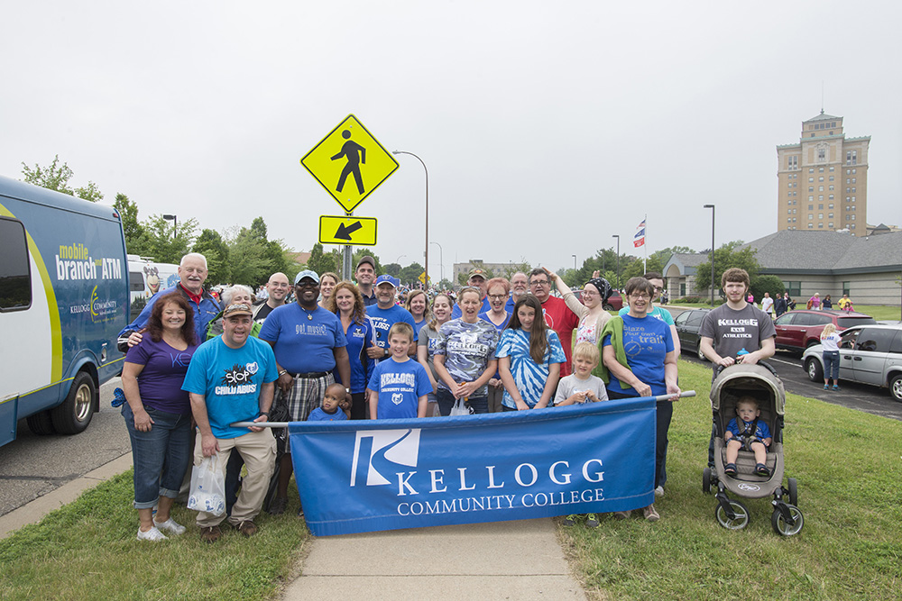 A group of KCC employees and their friends and family members pose for a group photo before walking in the Cereal Parade in 2015.