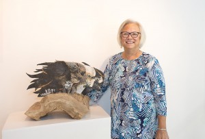 Battle Creek artist Mary Dey stands with her sculpture "Hope," part of her exhibit now showing at KCC's DeVries Gallery through Sept. 16.