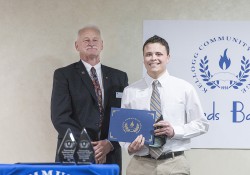 Hunter Mauk, right, accepts the award for Outstanding Full-Time Arts & Sciences Graduate from KCC President Mark O’Connell at the KCC Awards Banquet in April.