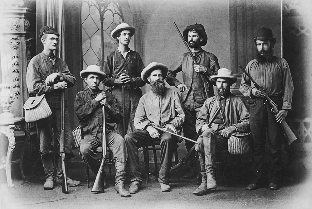 An archival image of hunters posing for a group photo. Part of the Kingman Museum photo archives on display at KCC through the end of 2016.