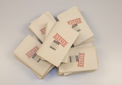 A stack of books wrapped in paper reading "banned."