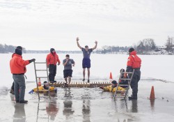 KCC Police Academy cadets jump into an icy lake during a Polar Plunge event to raise funds for Special Olympics Michigan.