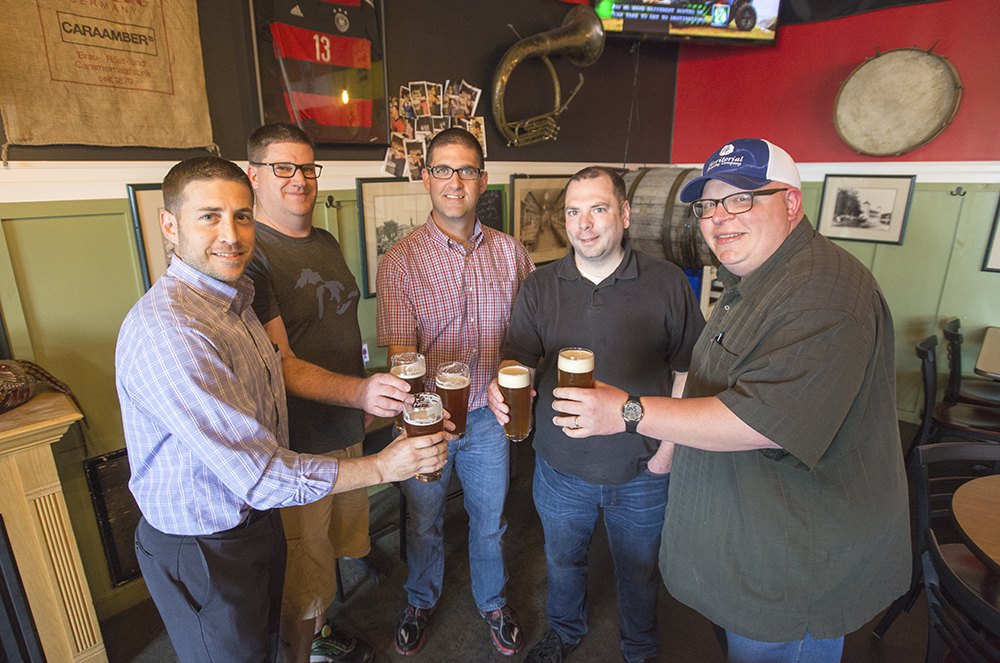 From left to right, Jeremy Wilson, Blair Foljahn, KCC Director of Public Information and Marketing Eric Greene, Territorial co-owner Charles Grantier and head Territorial brewer and co-owner Tim Davis taste Bruin Brew beer brewed for KCC's 60th anniversary at Territorial Brewing Company.