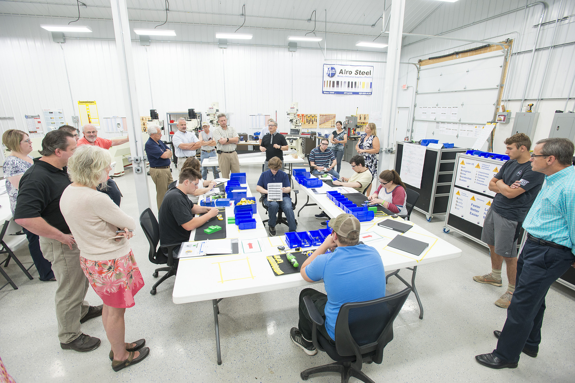 KAMA trainee family members, area employers, program funders and other community partners mingle and speak with the KAMA participants during a production run demonstration held during a meet-and-greet event at TNR Machine, Inc., in Dowling in July.