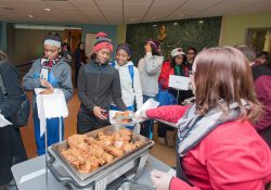 KCC employees serve students food during one of the College's annual Soul Food Luncheon events on campus.