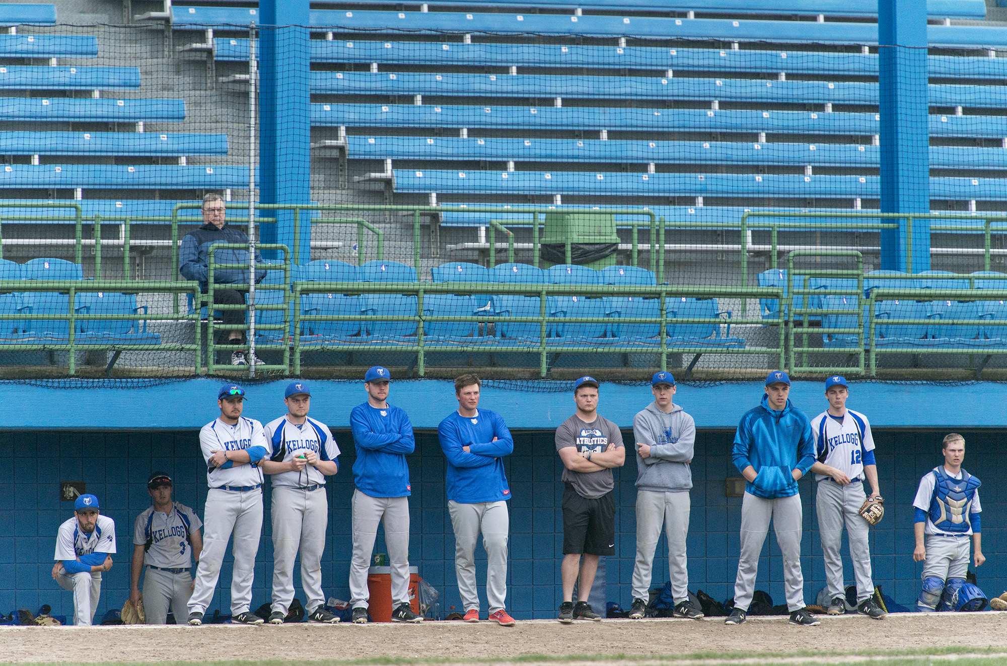 KCC baseball players watch the team play from the dugout during a home game at Bailey Park in Battle Creek.