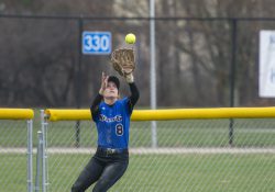 A KCC softball player catches a ball in the outfield during a home game at Bailey Park in Battle Creek.