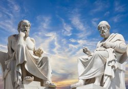 Statues of ancient philosophers against a deep blue sky.