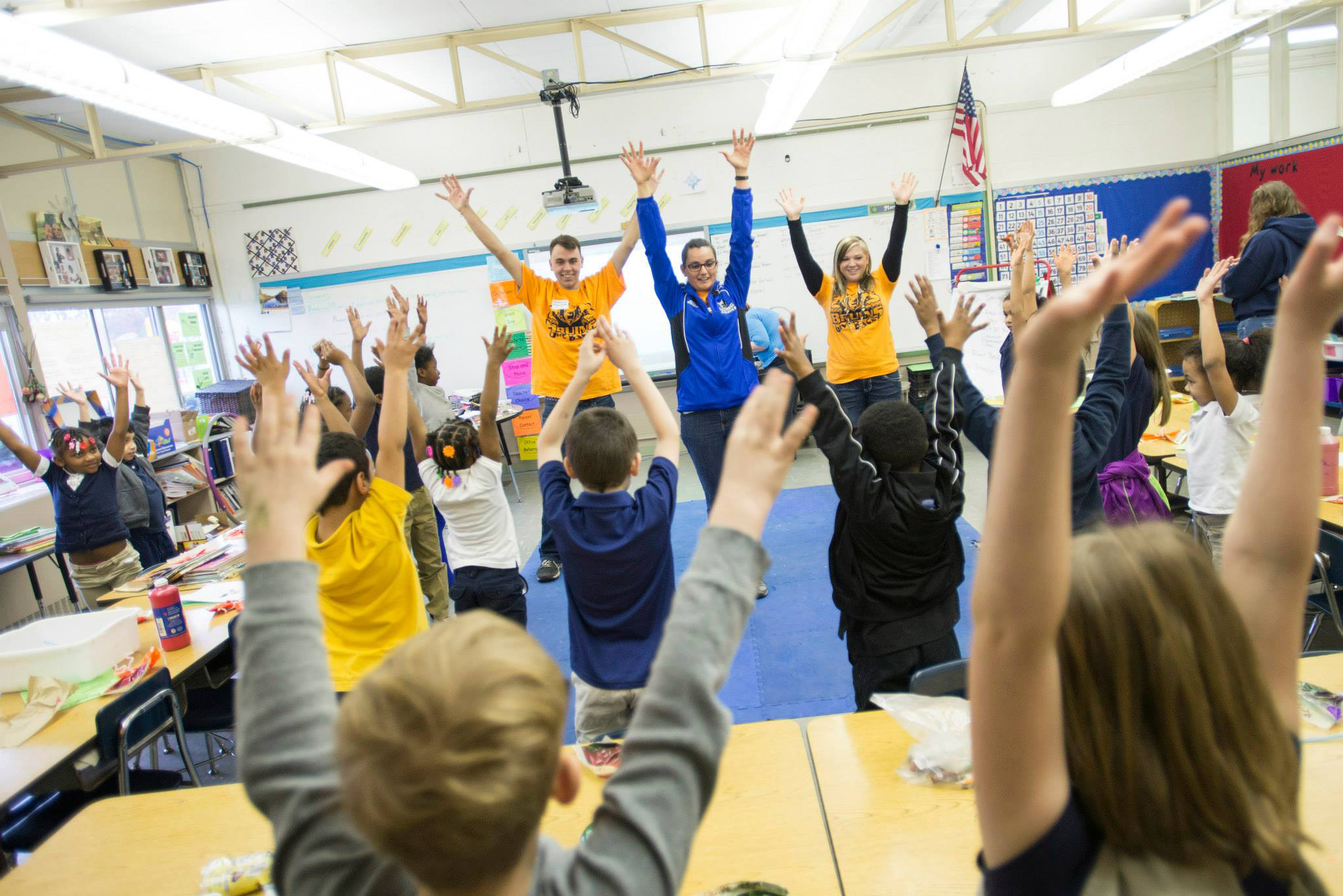 Bruins Give Back participants exercise with kids at Dudley STEM School.