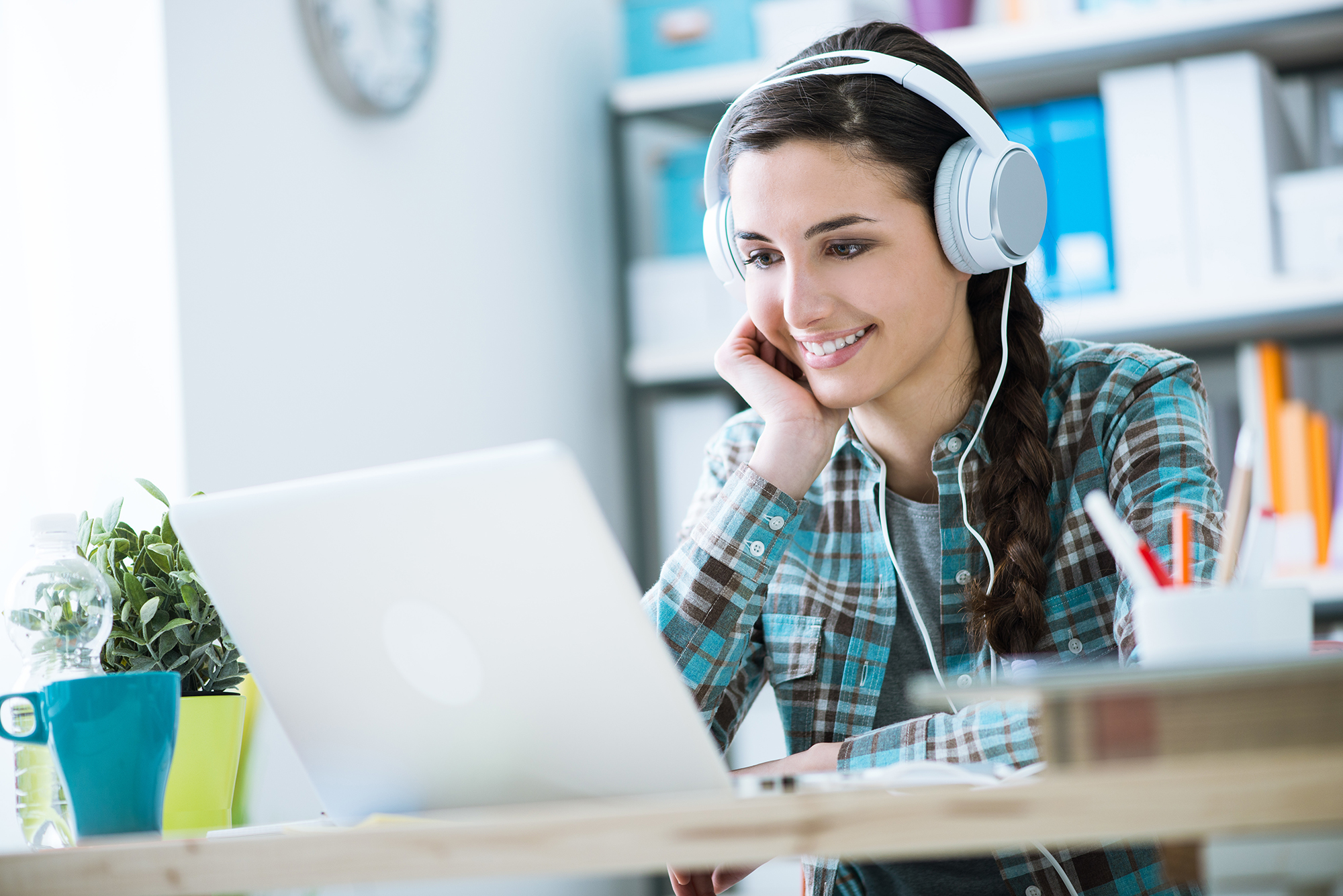 A student looks at a laptop in a photo illustrating online classes.