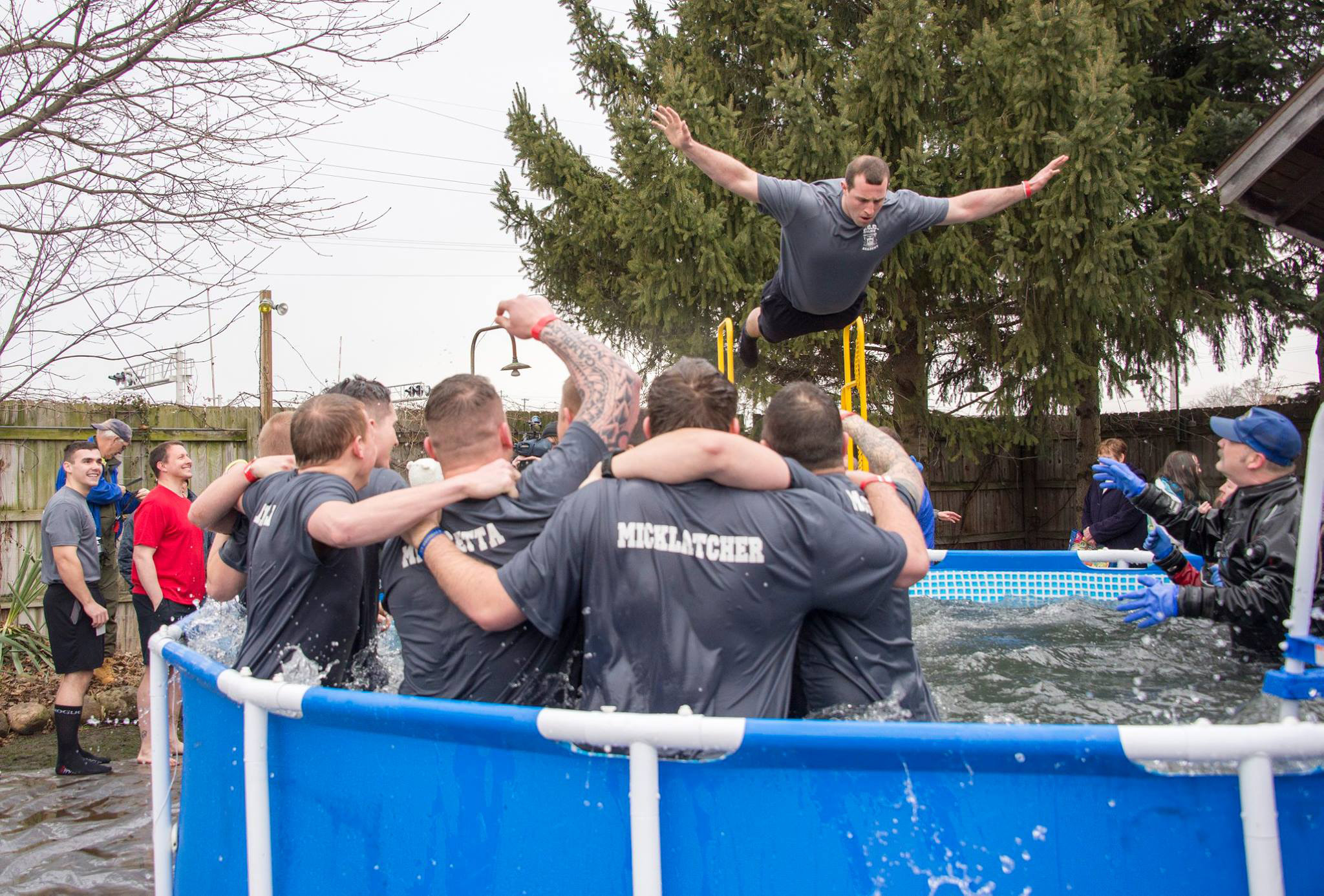A KCC Police Academy cadet jumps into a pool during a polar plunge event in 2017.