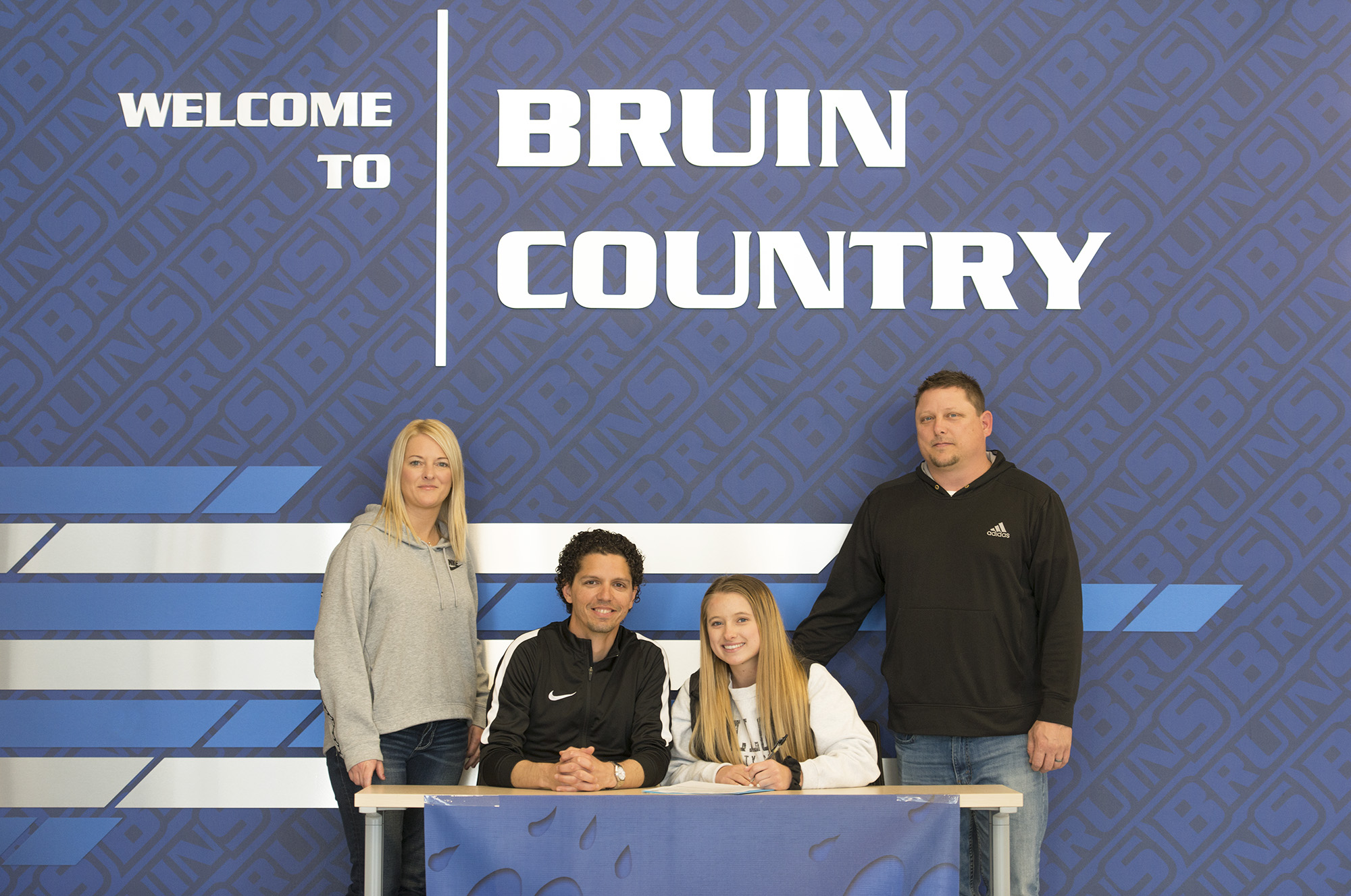 Pictured, from left to right, are Danielle Willis (mother), Head Women's Soccer Coach Eierí Salivia, Baylee Willis and Mitch Willis (father).