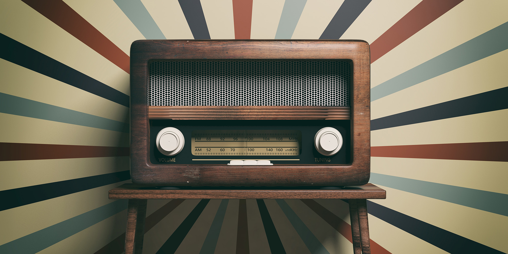 An old radio in front of colorful wallpaper.