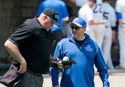 KCC Athletic Director Tom Shaw speaks with an umpire during a baseball game.