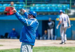 KCC Baseball Coach Eric Laskovy holds his hands up during a game.
