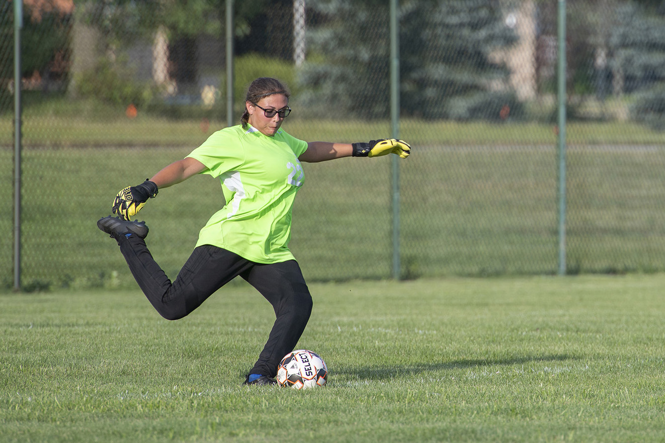 Goalkeeper Maya Ruelas kicks the ball during a home soccer game.