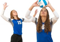 KCC volleyball players play volleyball.