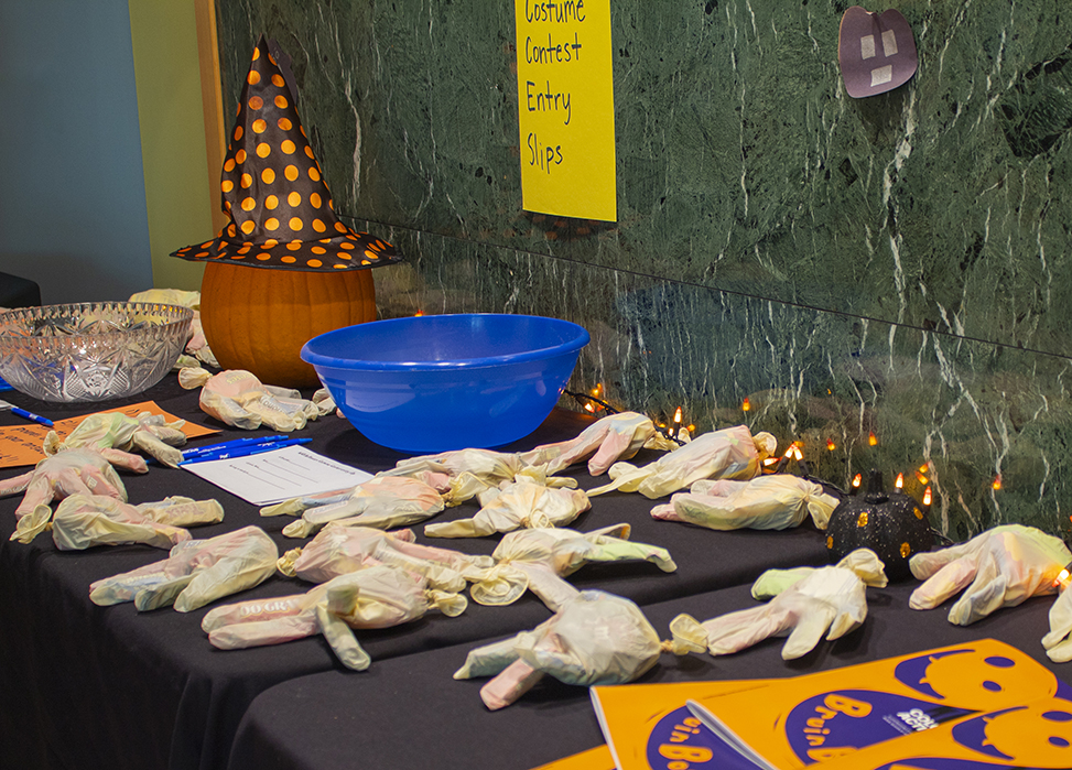 Table with Halloween decorations and pumpkin for contest..