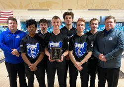 KCC Men's Bowling team posing with plaque