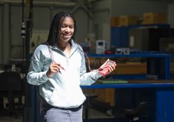 Student Zaire Gilbert holds an electrical meter tool in the College's Electricity and Electronics Lab.