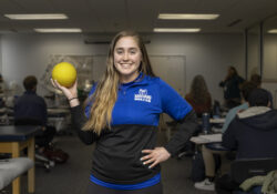 PTA student Lillian Fulcher holds an exercise ball while posing in the PTA Lab.