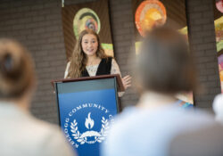 A student speaks at a podium during an event.