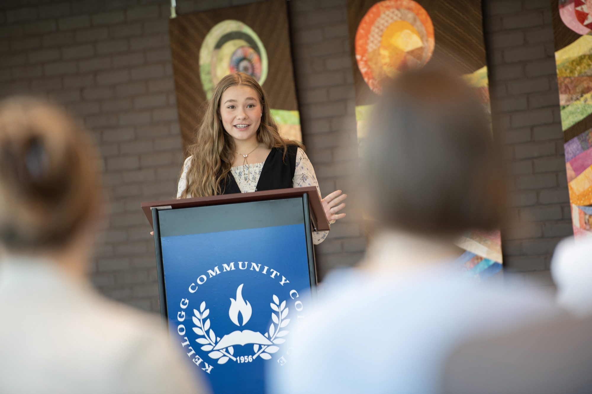 A student speaks at a podium during an event.