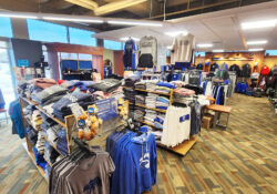 An interior view of the Bruin Bookstore showing various clothing items on sale.