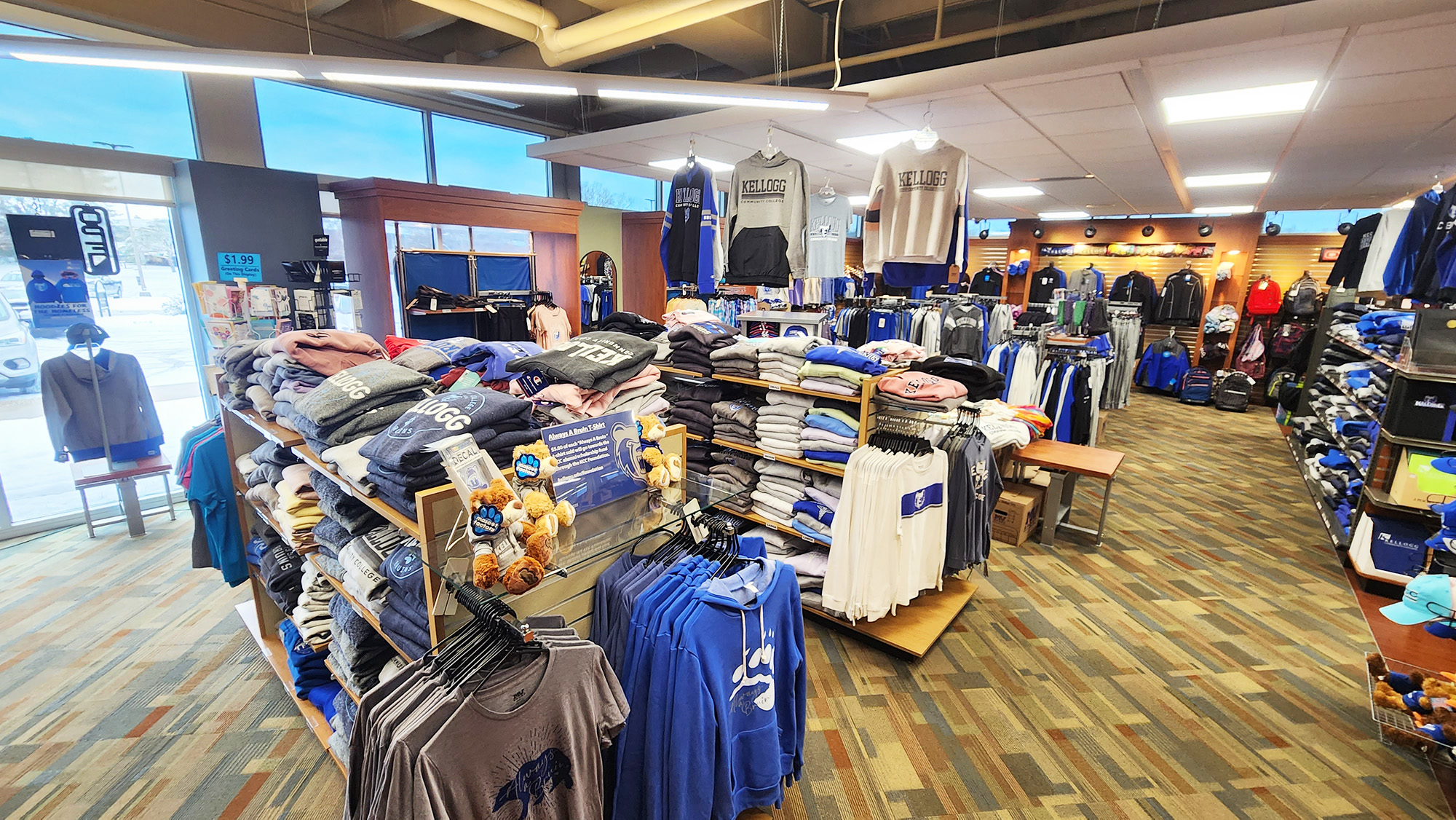 An interior view of the Bruin Bookstore showing various clothing items on sale.