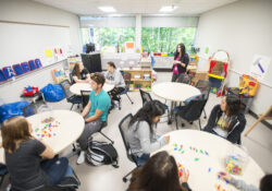 A professor instructs students in the Early Childhood Education Learning Lab on campus.