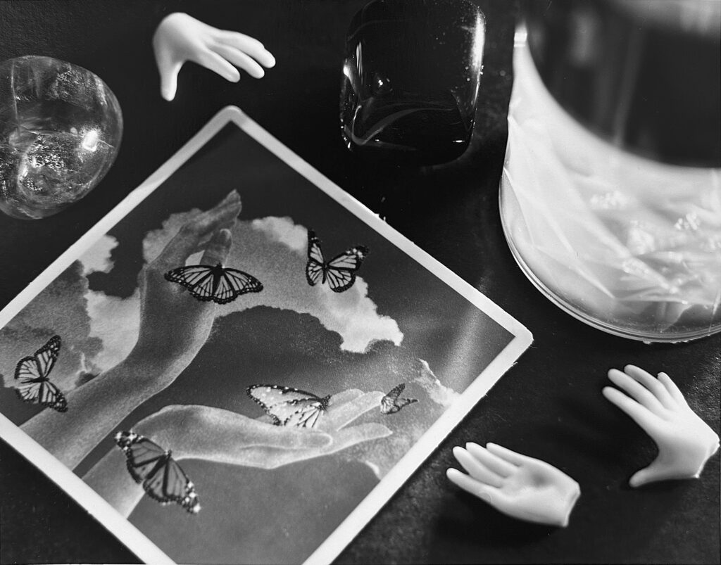 A black and white photo showing various items on a desk.