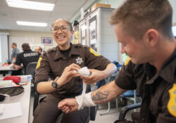 Corrections students practice wrapping bandages in class.