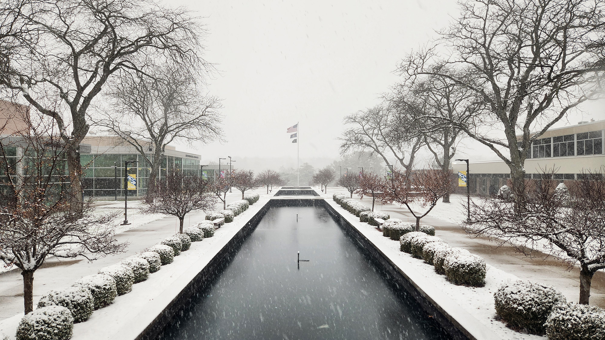 A view looking over the reflecting pools on campus on a snowy winter day.