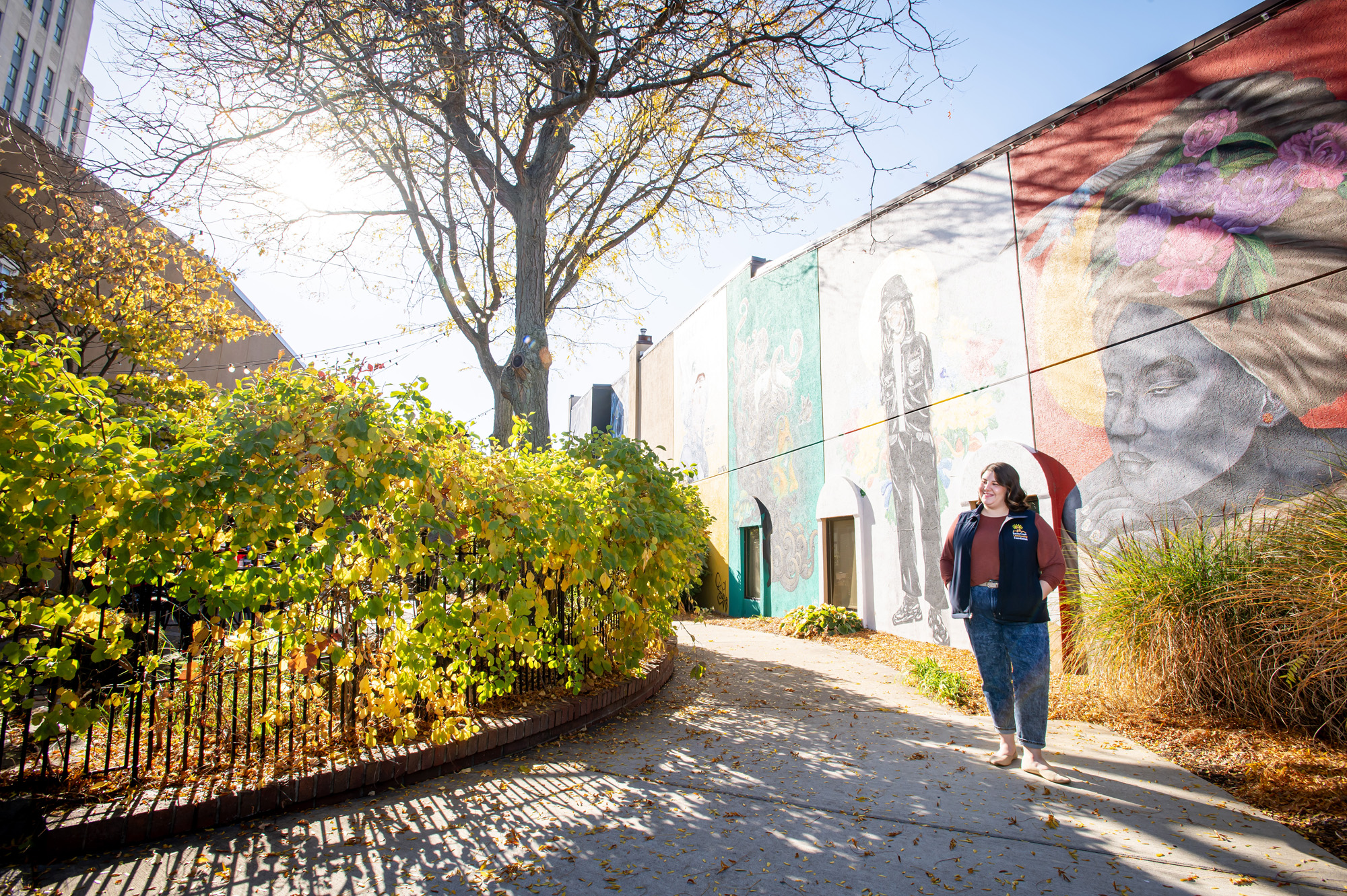 Kyra Hill pictured outside in front of a mural downtown.