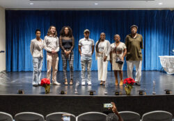 Graduates of a recent iACT Corrections Connect training program appear onstage during a recognition ceremony in July.