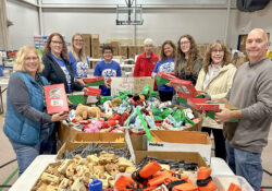 KCC volunteers stuff boxes for children during Bruins Give Back at the Battle Creek Outdoor Education Center in November 2024.