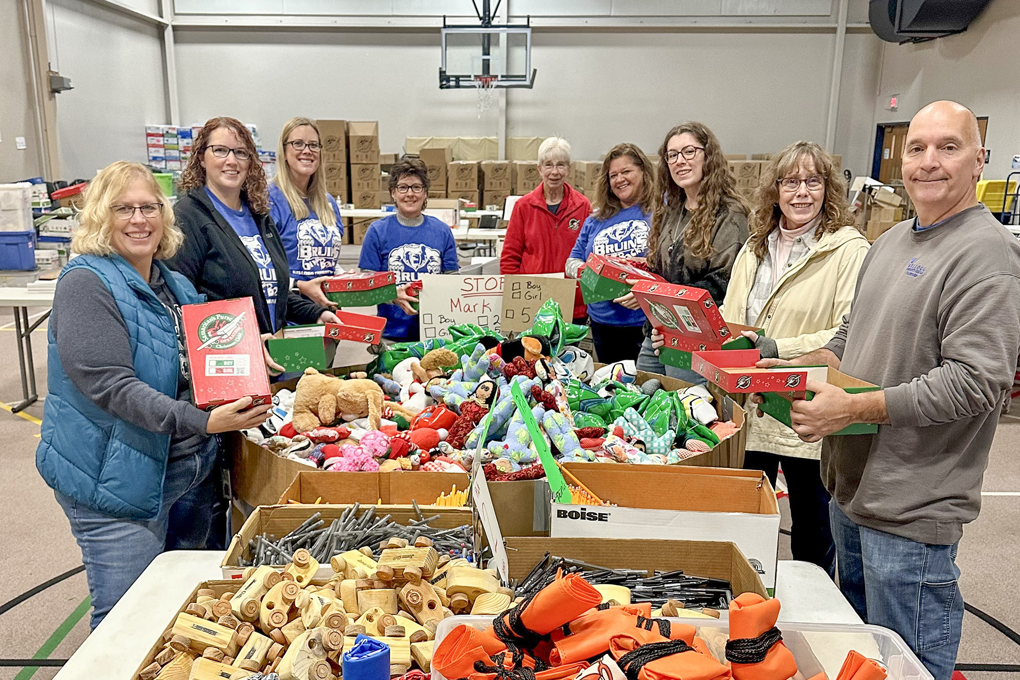 KCC volunteers stuff boxes for children during Bruins Give Back at the Battle Creek Outdoor Education Center in November 2024.