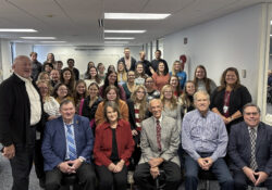 A large group photo of donors and PTA students and staff.