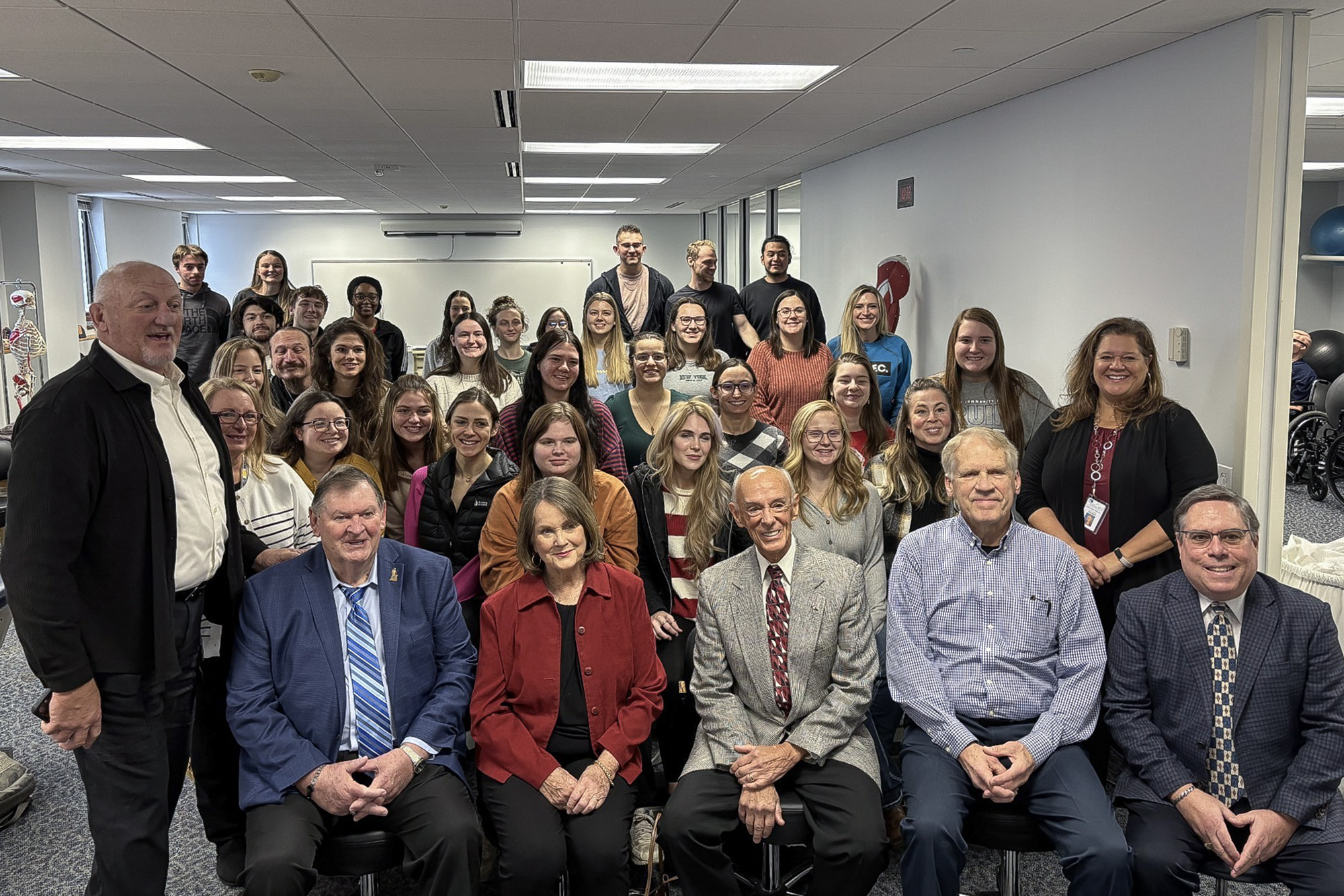 A large group photo of donors and PTA students and staff.