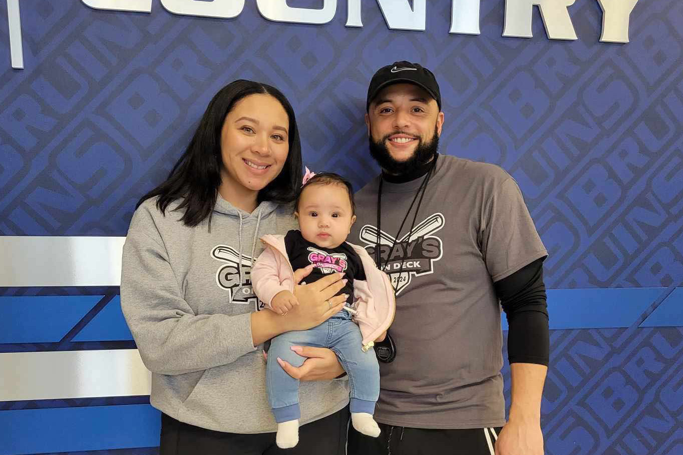 Evan Gray pictured with a woman holding a baby.