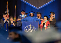 Maude Bristol-Perry gestures to the crowd of graduates after delivering her Commencement speech at Commencement.
